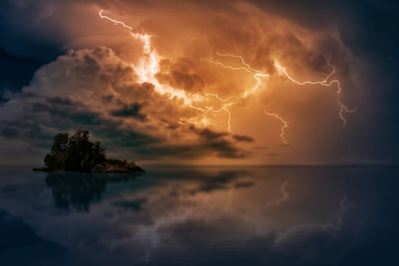 Lightning over the sea at dusk, with warm light breaking through storm clouds